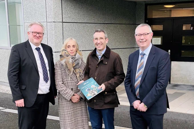 Me outside the building holding a report from AFBI alongside Director of Veterinary Sciences Division Dr Alastair Douglas, Chairperson Prof. Grace Mulcahy and CEO Dr Stanley McDowell.