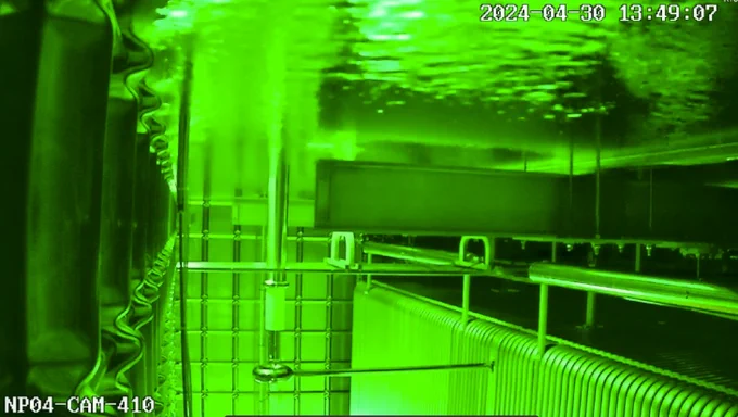 ProtoDUNE II: Characteristic gold colour seen within ProtoDUNE I, has been replaced by this luminescent green. This is due to cooling of the LAr it is filled with.  