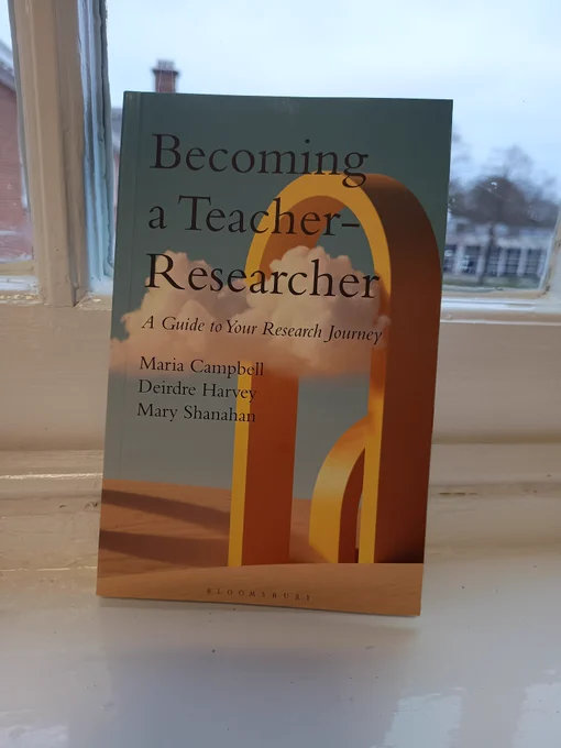 A book with the title 'Becoming a Teacher-Reaearcher: a guide to your research journey ' and the names of the editors below 