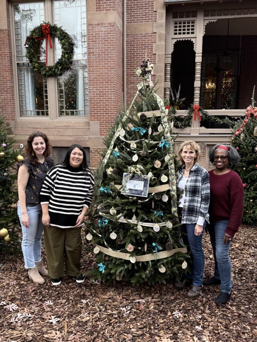 Members of the NC Community Foundation team in front of a tree at the Executive Mansion
