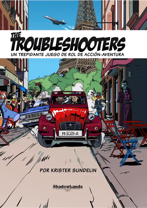 Portada del manual The Troubleshooters.
El arte es estilo comic y se observa una persecución entre dos coches antiguos en medio de las calles de París con la Torre Eiffel al fondo.