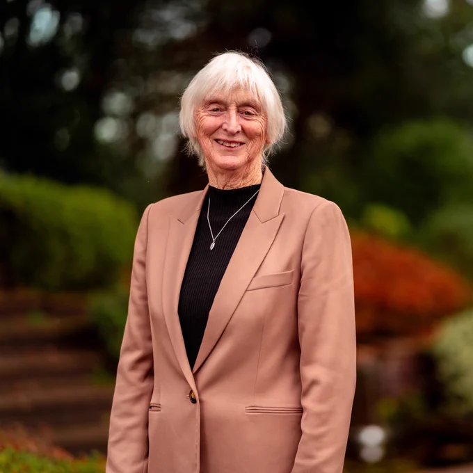 Baroness Sue Campbell standing in front of greenery as she is appointed as the new England Netball Chair.