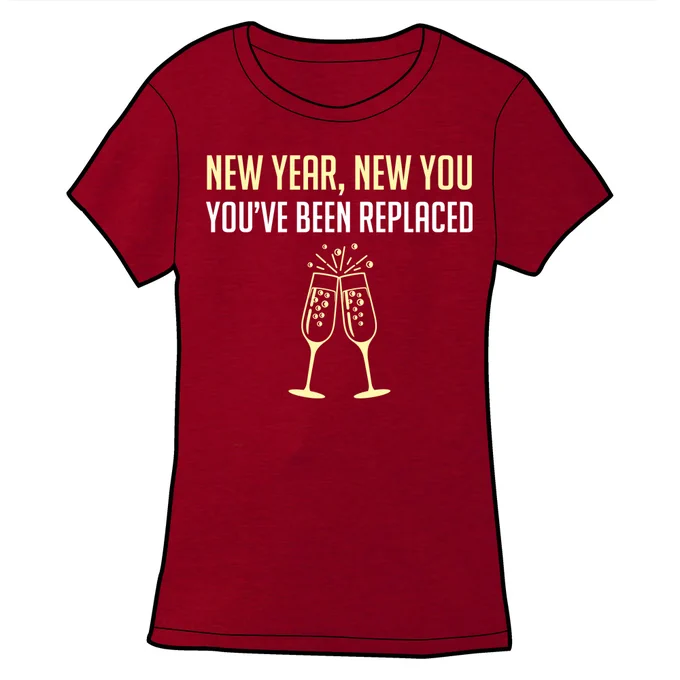 A fitted red t-shirt with light yellow text that says "New Year, New You. You've been replaced". Below this are two champagne glasses clinking. The bubbles have a crescent moon inside them.