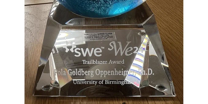 SWE 2024 Trailblazer award. A glass sphere on top of a glass stand engraved with Pola Goldberg Oppenheimer, PhD, University of Birmingham.