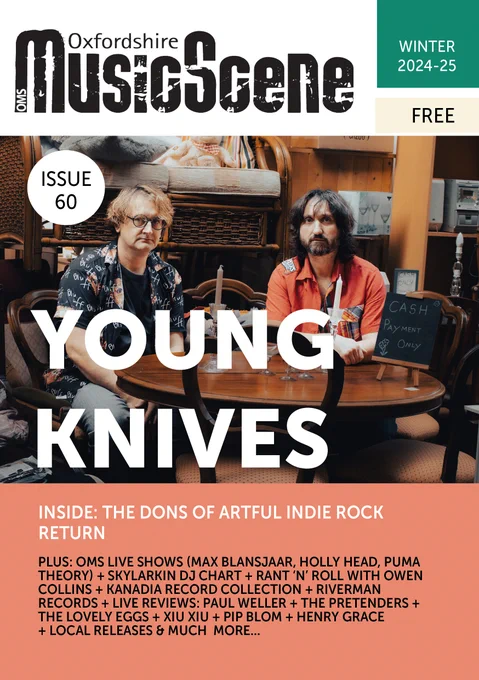 Young Knives band - boho styled cover photo by Hannah Carter: 2 gentlemen musicians seated at a mahogany style vintage round table set in a bric a brac store with kitch candles, glasses and 'cash only' blackboard. Cover of the Oxfordshire Music Scene Magazine Winter 24-25 Issue 60 reads: Inside: "The Dons of Artful Indie Rock Return" main content: Max Blansjaar, Holly Head, Puma Theory, Skylarkin, Owen Collins, Canada, Riverman Records, Paul Weller, The Pretenders, The Lovely Eggs, XIU XIU, PIP BLOM, Henry Grace & more. (Free). OMS logo at the top in b& w, green/cream  highlight boxes, and peach background colours used in sections. 