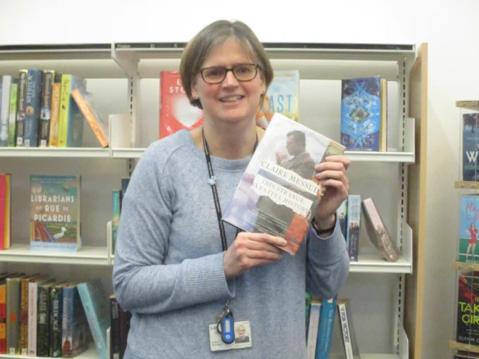 member of staff with book