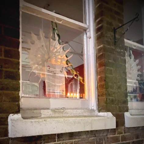 Rusthall Library lights up their windows with snowflake decorations to support Spellow Library