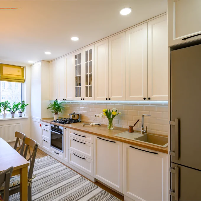 Kitchen illuminated by recessed lighting over the counter 