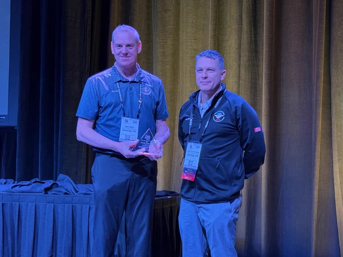 Major Ken Mick and Major Paul Faulkner from 1 Canadian Air Division Special Events Division receiving the Performer Pinnacle Award-Gold on behalf of the #RCAF member who contributed to the 2024 CF-18 Demonstration Team paint scheme, during the International Council of Air Shows Convention, in Las Vegas, Nevada.