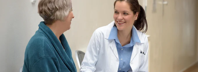 Smiling doctor talking to patient