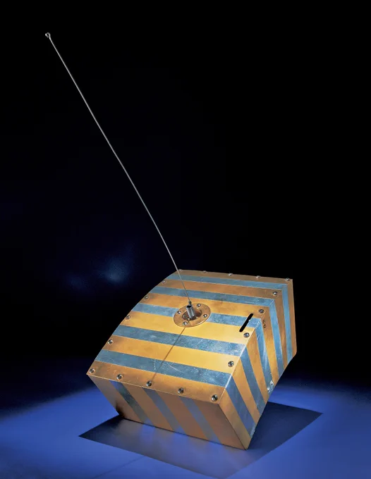 A striped wooden box with a mounted antenna, displayed against a dark background.