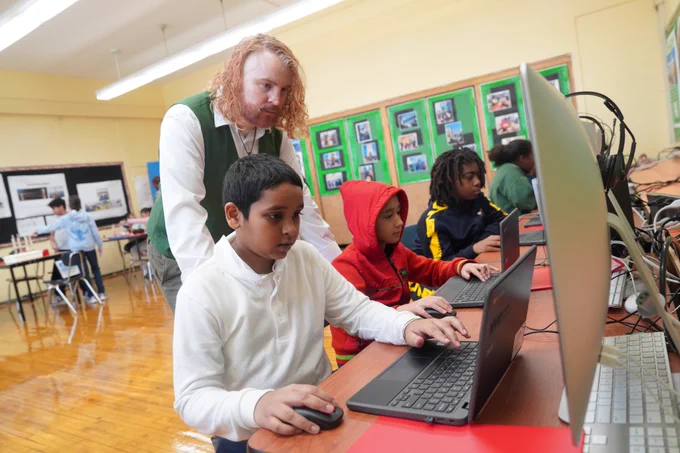 Students at PS 52 Magnet School learning how to code on computers for Computer Science Week.