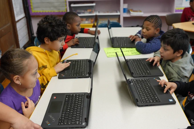 Students at The Floyd Bennett School learning how to code on computers for Computer Science Week.