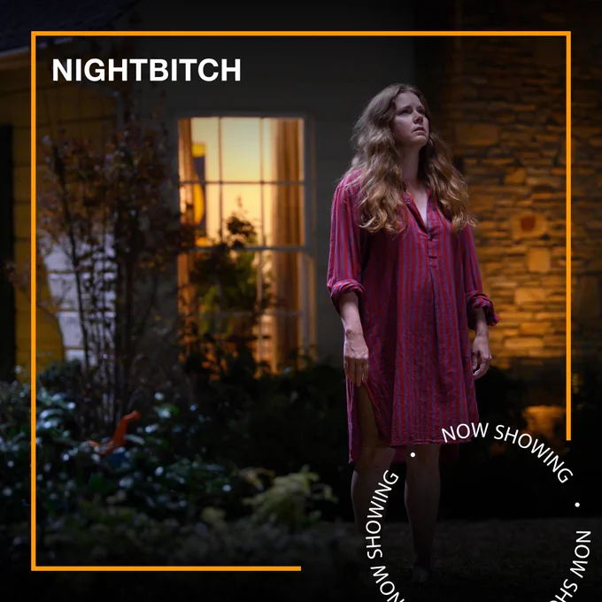 A woman stands outside her house in a night gown, looking anxious and staring up at the sky. Text - Nightbitch, Now Showing