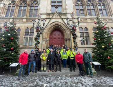 Image of police, fire service, paramedics street pastors, charities etc standing on the steps of Inverness Town Hall.