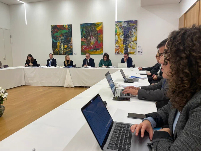 roundtable of civil society organisations' representatives with the polish minister of justice, white table, computers, art on the walls