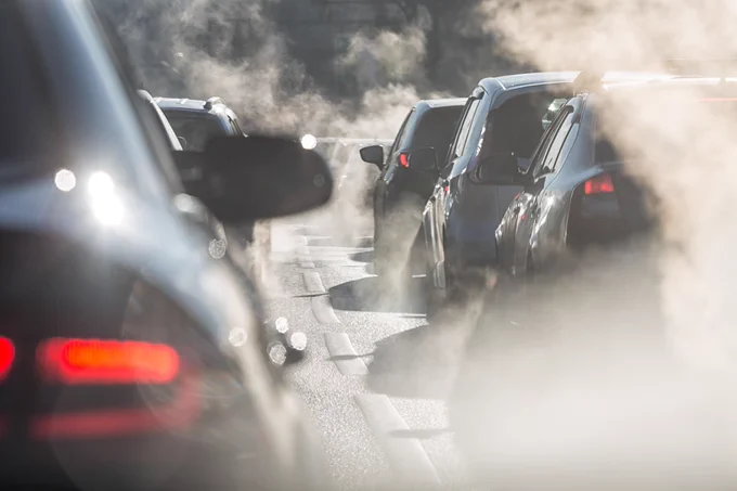 Cars in a traffic jam with lots of pollution