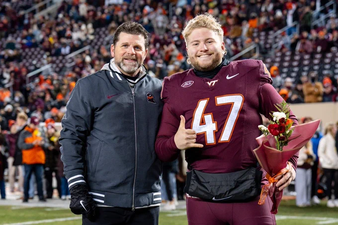 Football coach Brent Pry with Griffin Armstrong during senior night at the final home game of the season against the University of Virginia
