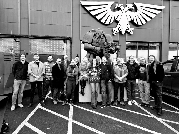 A group of Black Library authors outside the car park space marine