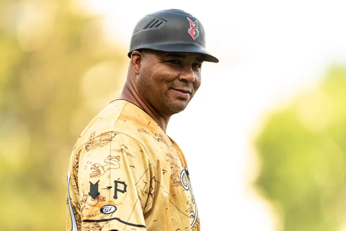 Former Indianapolis Indians manager Miguel Perez smiles while wearing a gold Prospects Weekend jersey.