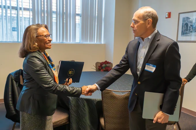 HUD Agency Head Adrianne Todman shaking hands with another person at the event.