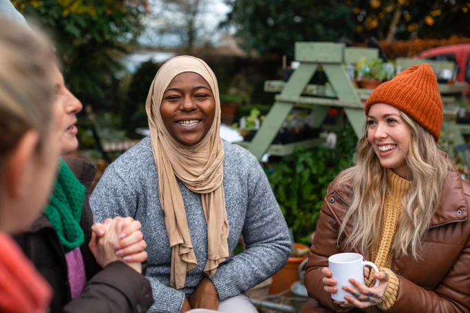 Group of friends outside in winter clothes talking