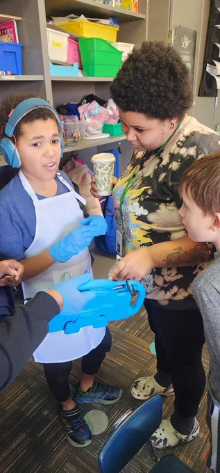 Students using communication device to deliver treats to staff. 