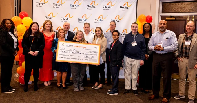 Penn-Mar Rep Allis Kensing holding the grant check with many other people surrounding her. 