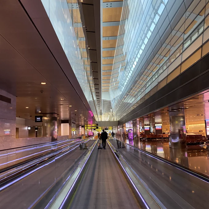 Looking down a travelator at  Doha airport. Lots of lights and fun perspective that makes it look like warp speed.