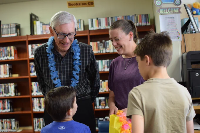 Gov. Evers talks to a mom and her sons at the library. 