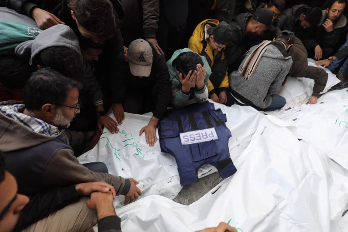 Relatives of journalists Ayman al-Gedi, Faisal Abu Al Qumsan, Ibrahim Sheikh Ali, Mohammad Al-Lada and Fadi Hassouna, who lost their lives after Israeli forces hit the live broadcasting vehicle belonging to Al-Quds al-Youm television (alqudstoday-tv) at the Nuseirat Refugee Camp, mourn as they hold funeral ceremony for them at Al Awda Hospital in Gaza City, Gaza on December 26, 2024. (Photo by Moiz Salhi/Anadolu via Getty Images)
