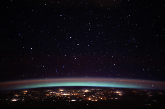 The city lights at the intersection of Europe and Asia sparkle underneath an atmospheric glow and a starry night sky as the International Space Station orbited 262 miles above into an orbital sunset.