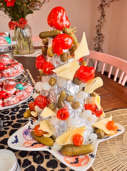 A cone shaped display of pickles, olives & cheese.it looks quite…nibbled.