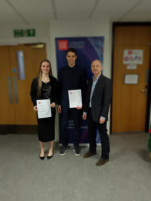 Prize winners receive their certificates.