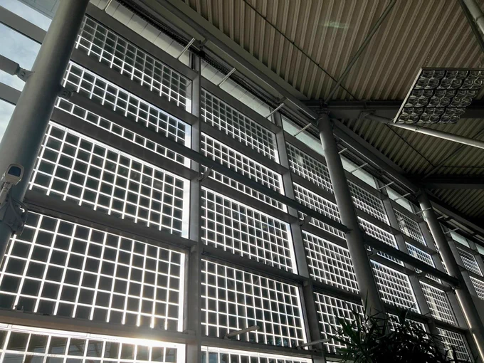 Solar PV facade with light shining through between the cells