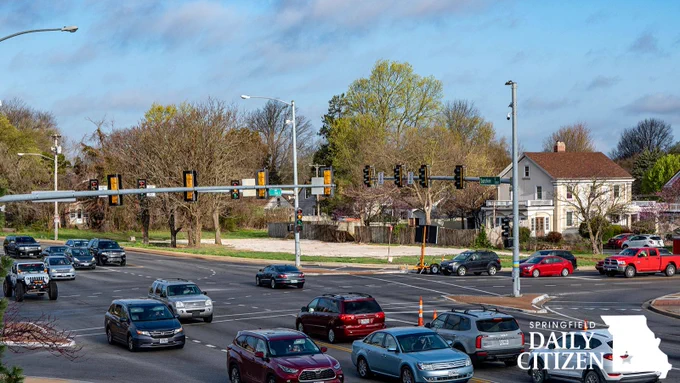 A section of the 2.6-acre area at East Sunshine Street and South National Avenue is behind weekday morning traffic at the intersection. A request to rezone the lots from residential to a general retail district has drawn strong objections from neighboring residents in University Heights. (Photo by Jym Wilson)