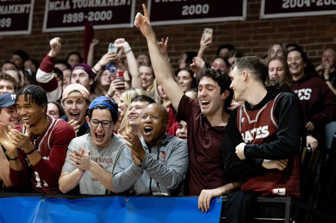President Garry W. Jenkins cheers in the student section in Alumni Gym during the Bates women's basketball team's first round NCAA tournament victory over Brooklyn College in March.