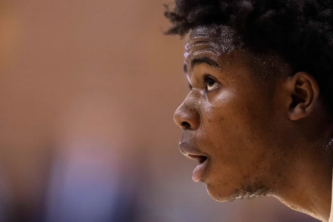 Close up of Bates basketball player David Omasombo '26 as he looks intently (perhaps at the ball) during a Bates v. Bowdoin matchup in February.