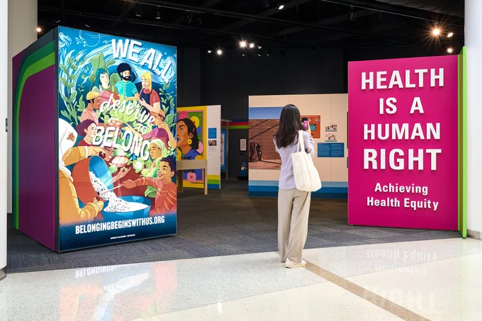 Young girl takes photo at CDC Musuem sign.