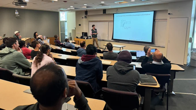 A scientist presents to a packed room