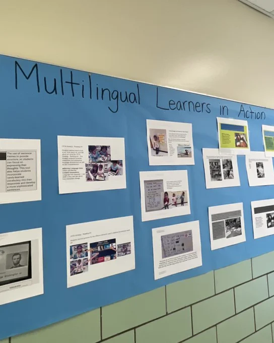 Photo of a bulletin board in a school hallway; the bulletin board header reads "Multilingual Learners in Action"