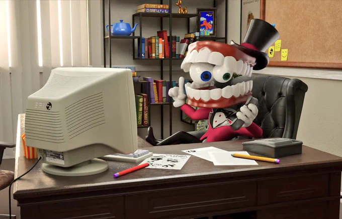 Caine in his office from TADC. In the background is a bookcase.