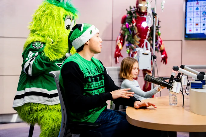 jason sits with patients and vic in a studio doing bingo