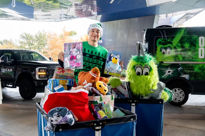 Jason and vic pose with some of the toys collected for the toy drive 