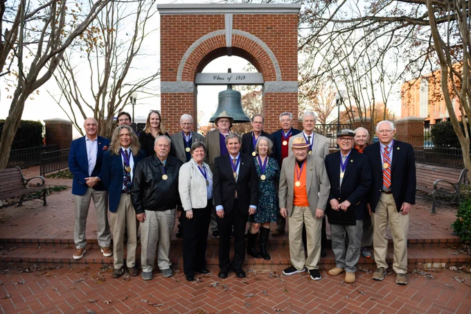 A group of people posing for a photo in the Carillon Garden.