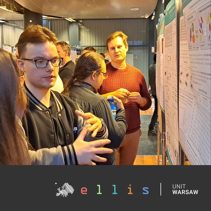 Group of individuals engaging in discussion in front of a poster presentation at an Ellis Unit Warsaw event.