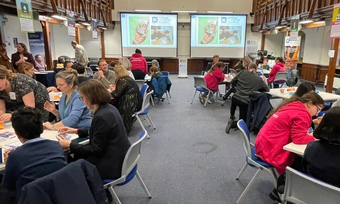 National Centre for Resilience workshop with multiple people playing the Are You Prepared? card game together. 