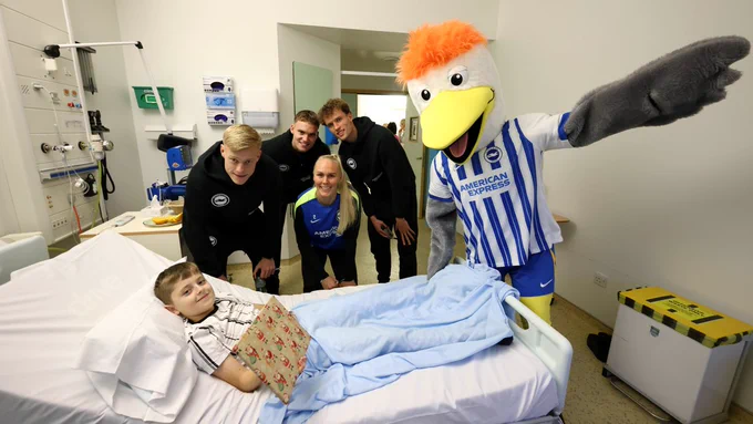 JP Van Hecke, Bart Verbruggen, Mats Wieffer, Maria Thorisdottir and Gully pose with a young boy at Royal Alexandra Hospital in Brighton.