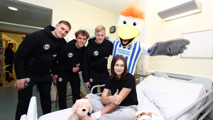 JP Van Hecke, Mats Wieffer, Bart Verbruggen and Gully pose with a young girl at the Royal Alexandra Hospital in Brighton.