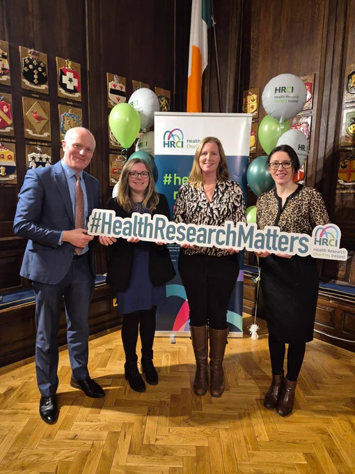 Fighting Blindness CEO, Finbarr Roche, Research Officer, Shannon Lee, and Research Manager, Rachel Birmingham, together with Prof. Sarah Doyle are holding the #HealthResearchMatters HRCI logo.
